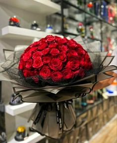 a bouquet of red roses sitting on top of a table