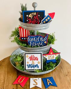 three tiered trays with patriotic decorations on top and flags in the bottom for decoration