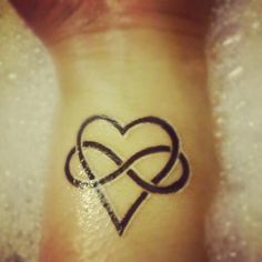 a heart tattoo with two intertwined hearts