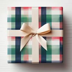 a present wrapped in plaid paper with a bow