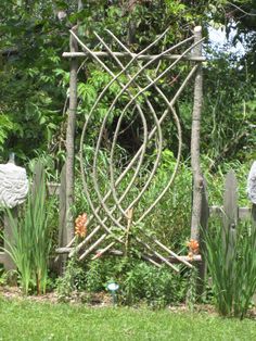 a garden gate made out of sticks and stones