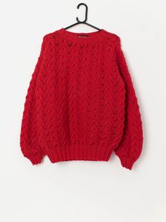 a red sweater hanging on a hanger