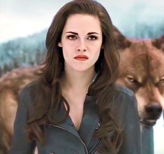 a woman standing in front of two wolfs with her face close to the camera