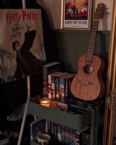 a wooden guitar sitting on top of a shelf next to a book case filled with books