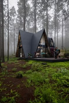 a tent in the middle of a forest with people sitting on it and looking at something