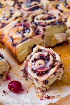 a close up of a pastry with cherries on it