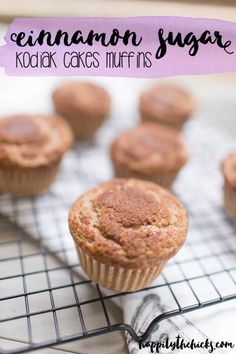 a muffin on a cooling rack with the words cinnamon sugar kodiak cakes muffins