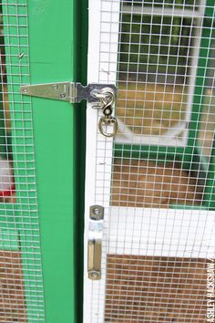 a close up of a green door with a pair of scissors