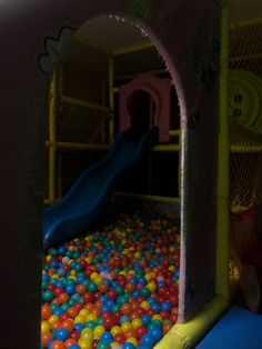 a child's play area with balls and a slide