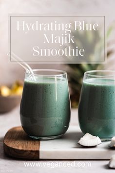 two glasses filled with blue and green smoothie