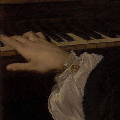 a close up of a person's hand playing the piano