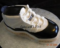 a white and black shoe cake sitting on top of a plate