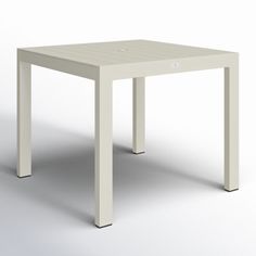 a small white table on a plain surface with no one around it or someone else