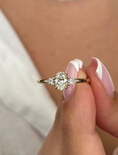 a close up of a person holding a ring with a diamond in it's middle