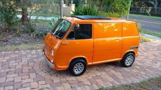 an orange van is parked on the side of the road