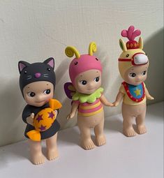 three little dolls are standing next to each other