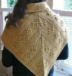 a woman wearing a yellow knitted shawl