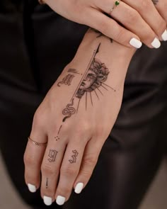 a woman's hand with a tattoo on it