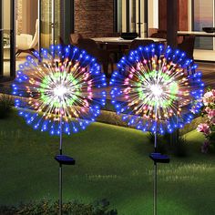 two colorful fireworks are lit up in the yard