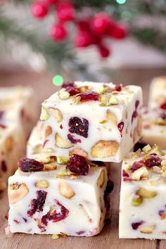 white chocolate with cranberry and pistachio toppings on a wooden table