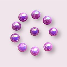 purple pearls arranged in a circle on a pink background