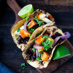 two tacos with black beans, carrots and cilantro