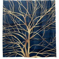 a blue rug with gold tree branches on the top and bottom, against a dark blue background