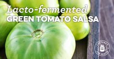 green tomatoes sitting on top of a wooden table with the words lacto - fermented green tomato salsa