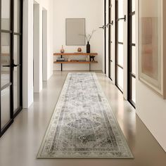 the hallway is clean and ready for guests to use it as an entrance way in this home