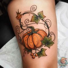 a tattoo with pumpkins and leaves on it