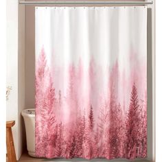 a shower curtain with pink and white trees in the background on a beige floor next to a toilet