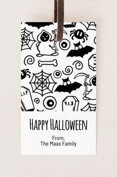 a happy halloween gift tag hanging on a wall with the words happy halloween from the masas family