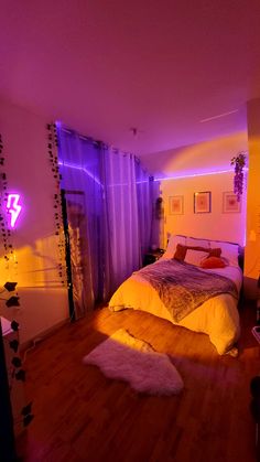 a bed room with a neatly made bed and purple lights