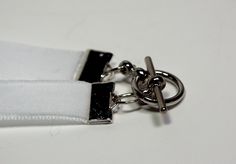 a close up of a white zipper with two metal rings