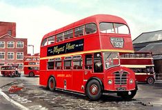 a red double decker bus driving down a street