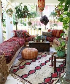 a living room filled with lots of plants and furniture