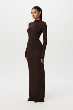 Our smooth-to-the-touch maxi dress is minimal chic. Designed with a mock neckline, long fitted sleeves and a body accentuating finish. Back zipper closure makes it effortless to put on. Style with flats or heels for ultimate versatility. Smooth Collection Import 92% Viscose Rayon, 8% Spandex Model is wearing size XS Tr Heels For Maxi Dress, Long Black Bodycon Dress Outfit Casual, Fall Long Dress Outfit, Body Con Maxi Dress Outfit, Long Dress With Boots, Long Bodycon Dress Outfit, Classy Wedding Guest Outfit, Wedding Guest Dress Winter, Long Sleeve Maxi Dress Black