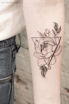 a rose and triangle tattoo on the arm