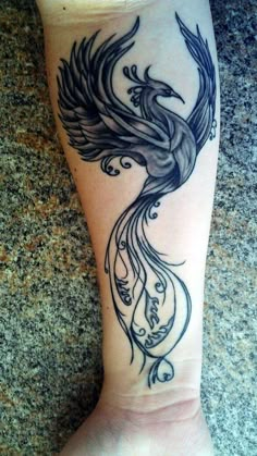 a woman's foot with a bird tattoo on the side of her leg,