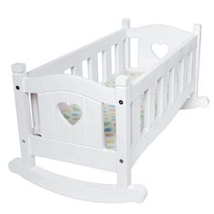 a white baby crib with a heart on the top and bottom rail, in front of a white background