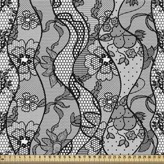 an abstract black and white lace pattern with flowers on the side, as well as dots