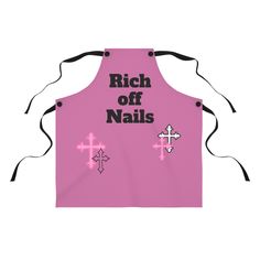 a pink apron with the words rich off nails on it and crosses in black lettering