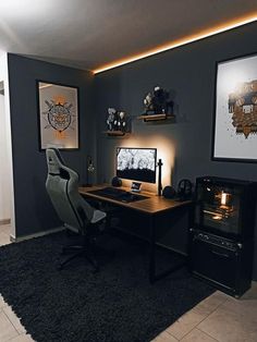 a desk with a computer on top of it in front of two pictures and a fireplace