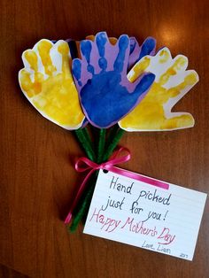 handprinted flowers with a note attached to it