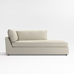 a white couch sitting on top of a white floor