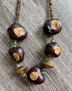 This 26" necklace features a magnetic screw clasp, brass beads, brass bead caps, Swarovski crystal faceted beads, and buckeye or horse chestnut seed pods. Chestnut Horse, Seed Pods, Bead Caps, Chestnut, Faceted Bead, Primitive Decorating, Chain Styles, Swarovski Crystals, Favorite Jewelry