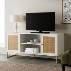 a flat screen tv sitting on top of a white entertainment center