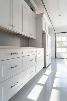 the kitchen is clean and ready to be used for cooking or cleaning up with white cabinets