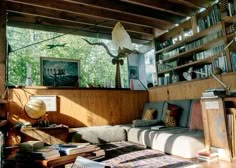 a living room filled with furniture and lots of books