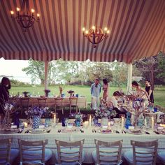 a group of people standing around a table